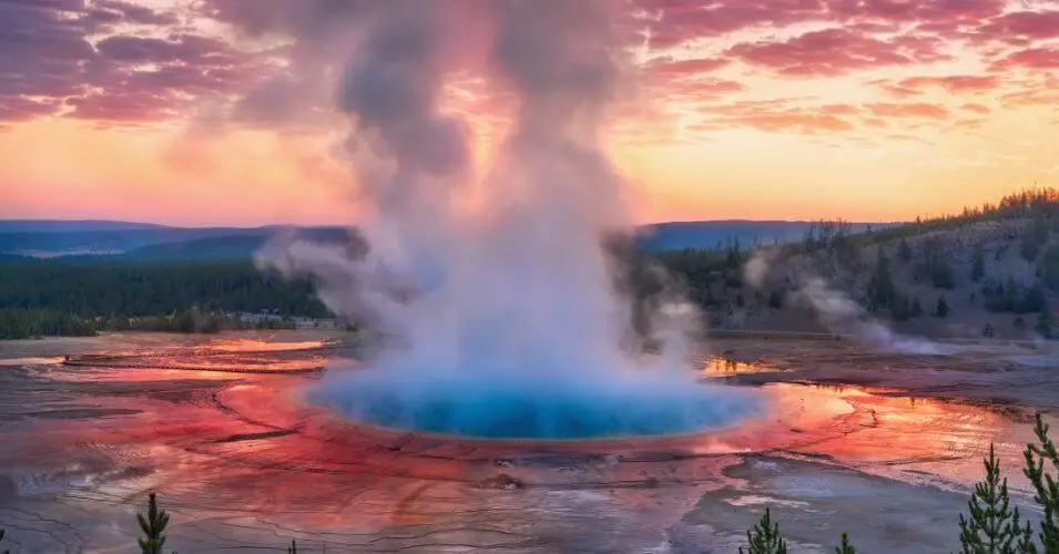 best time to visit yellowstone blog header of geyser erupting